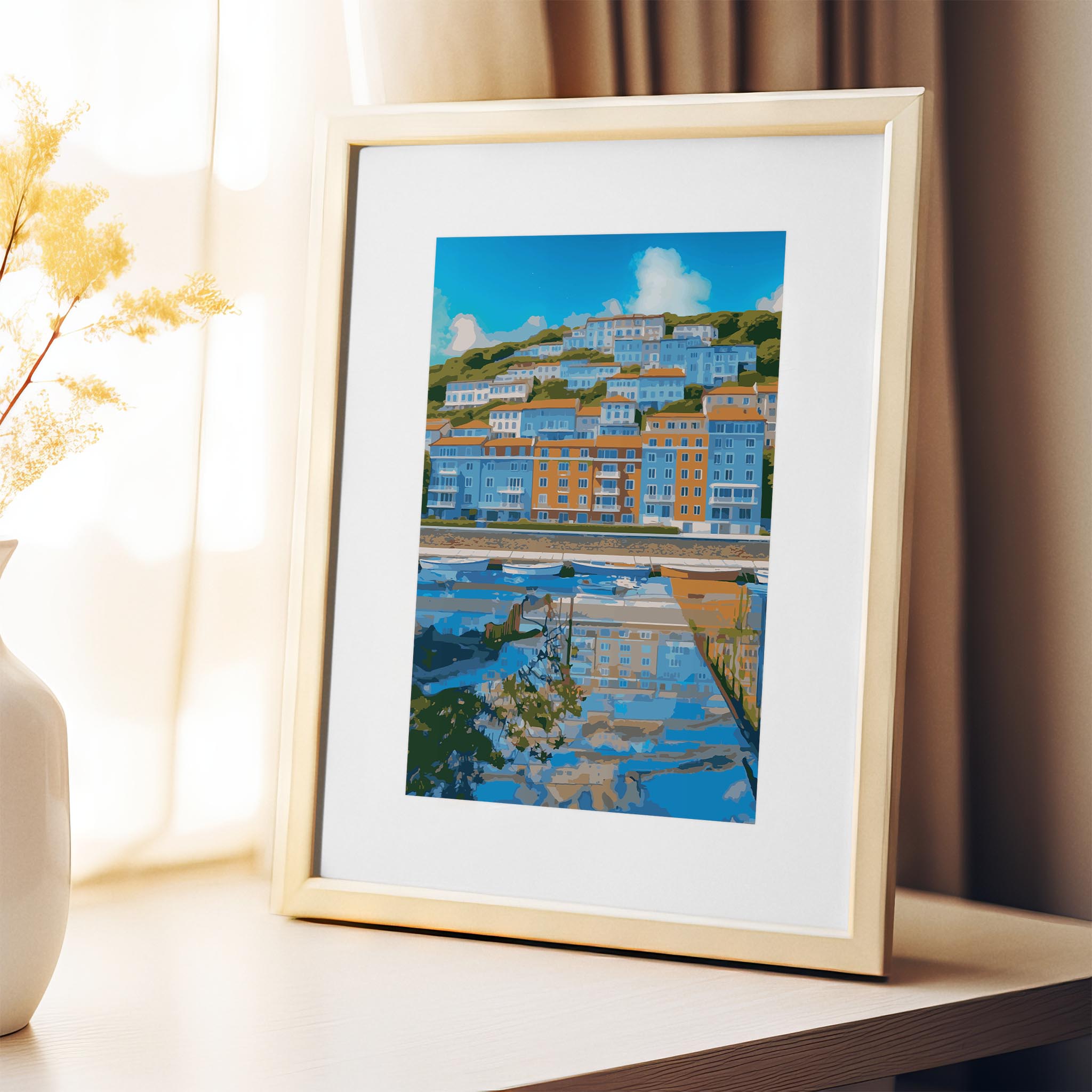 Coastal cityscape wall art showcasing colorful hillside buildings in shades of blue and orange, reflected in a calm waterfront marina with small boats and a bright blue sky overhead
