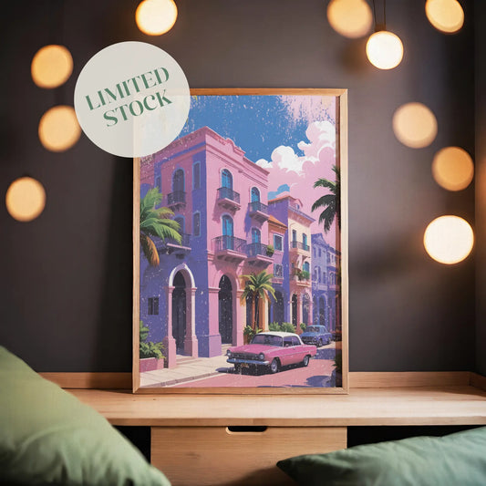 Printable wall art of colorful pastel buildings with balconies, palm trees, and a vintage pink car parked on the street under a sunny sky, perfect for tropical, retro-inspired home decor