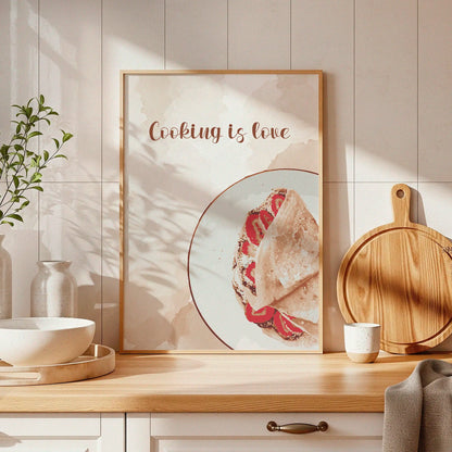 Minimalist kitchen wall art featuring a crepe with fresh strawberries on a white plate and the hand-lettered phrase 'Cooking is love' in elegant script, ideal for adding warmth to any culinary space