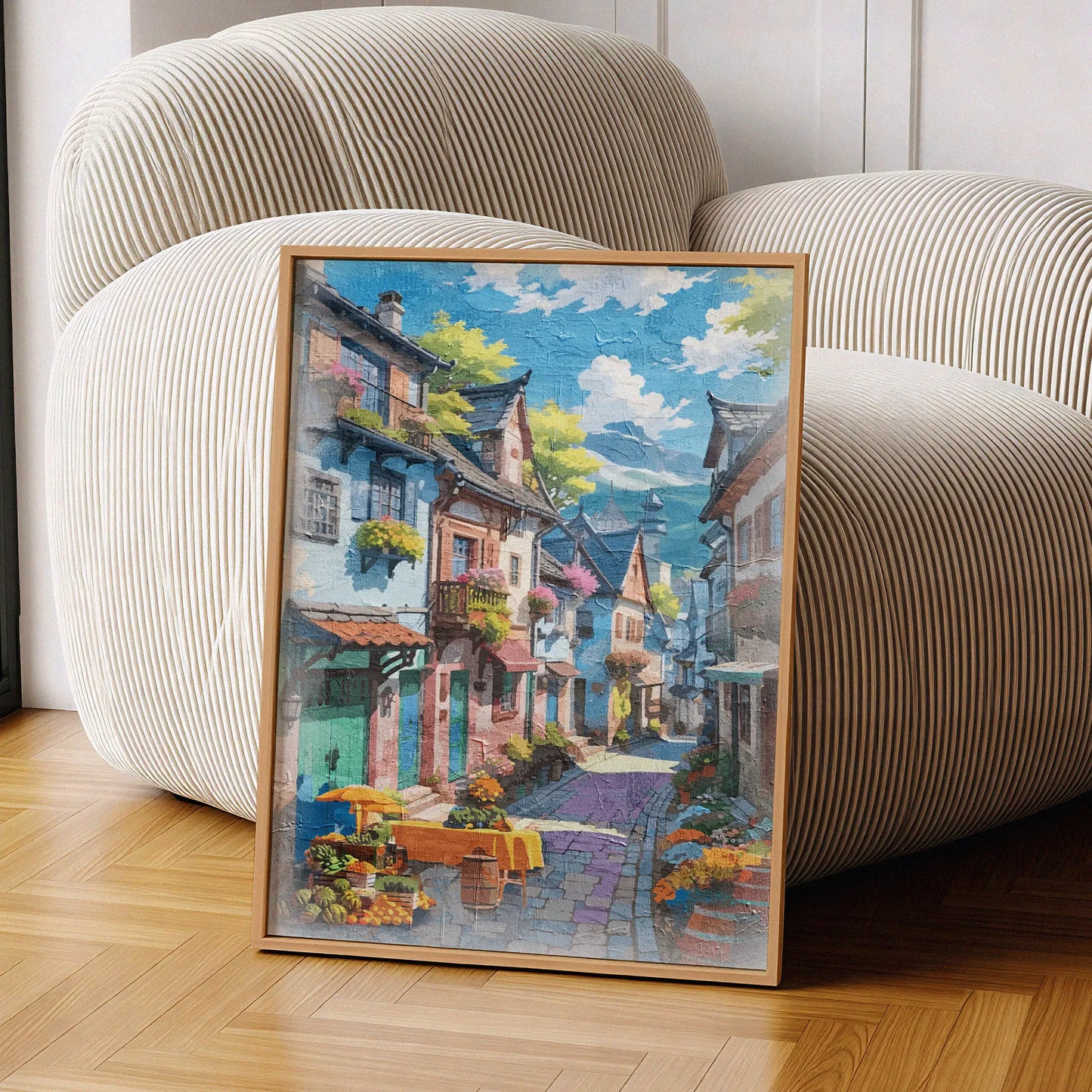 Charming printable wall art of a colorful European-style village street, lined with flower-filled balconies, cobblestone paths, and a market table with fruits and flowers under a sunny blue sky, perfect for travel-inspired, vintage, or Mediterranean-themed decor