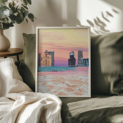 Modern cityscape wall art featuring futuristic skyscrapers along a beach shoreline, with soft sand in the foreground and a vibrant pastel sunset sky blending shades of pink, orange, and purple