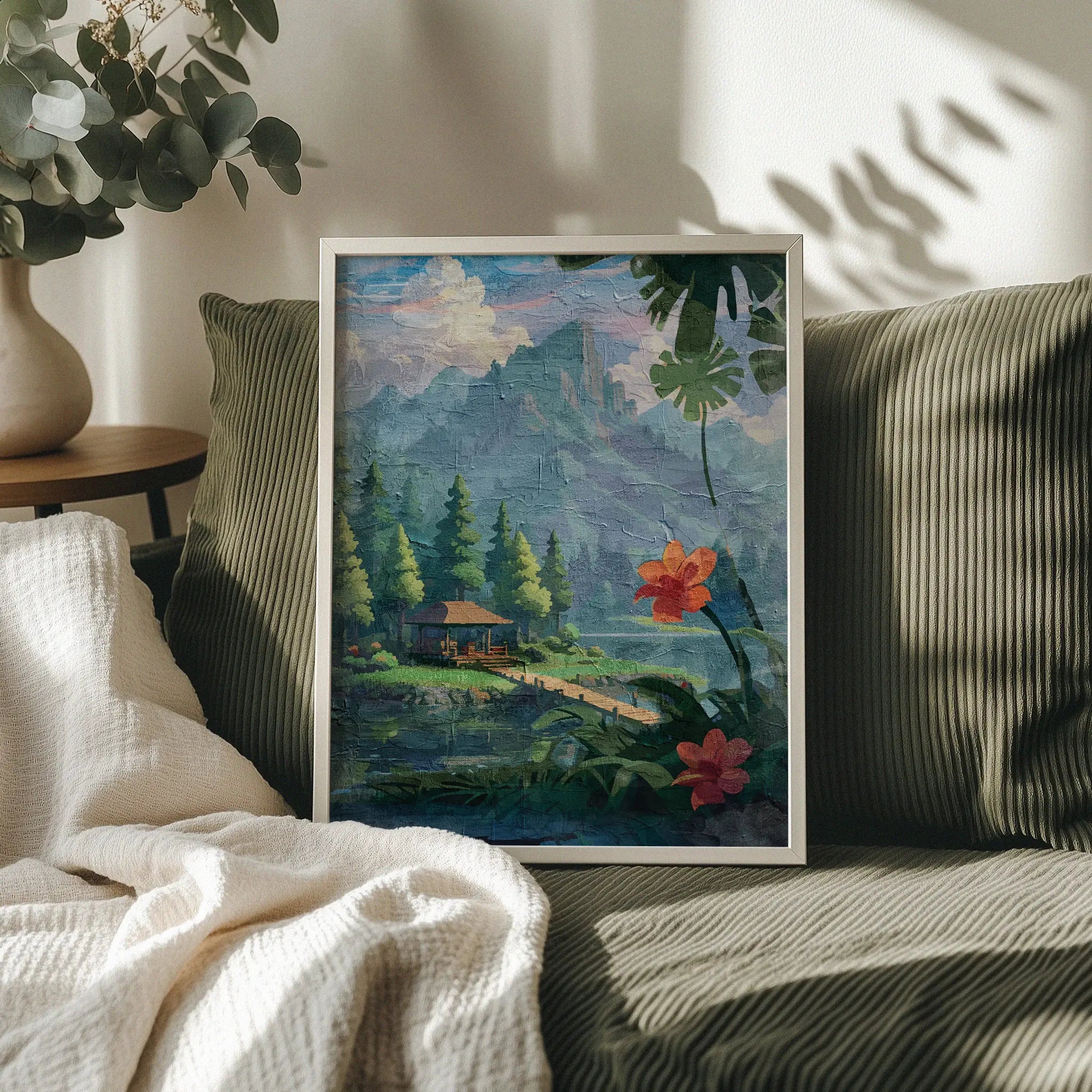 Tropical forest-themed printable wall art featuring a peaceful wooden cabin by a lake, surrounded by pine trees and distant misty mountains, with large tropical leaves and vibrant red-orange flowers in the foreground - perfect for nature lovers, retreat-inspired, or jungle-style decor