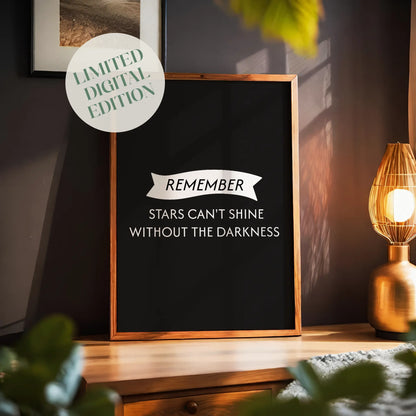 Inspirational printable wall art with the quote 'Remember, stars can't shine without the darkness' in elegant white typography on a black background, featuring a ribbon banner design, perfect for home, office, or bedroom decor with a motivational touch