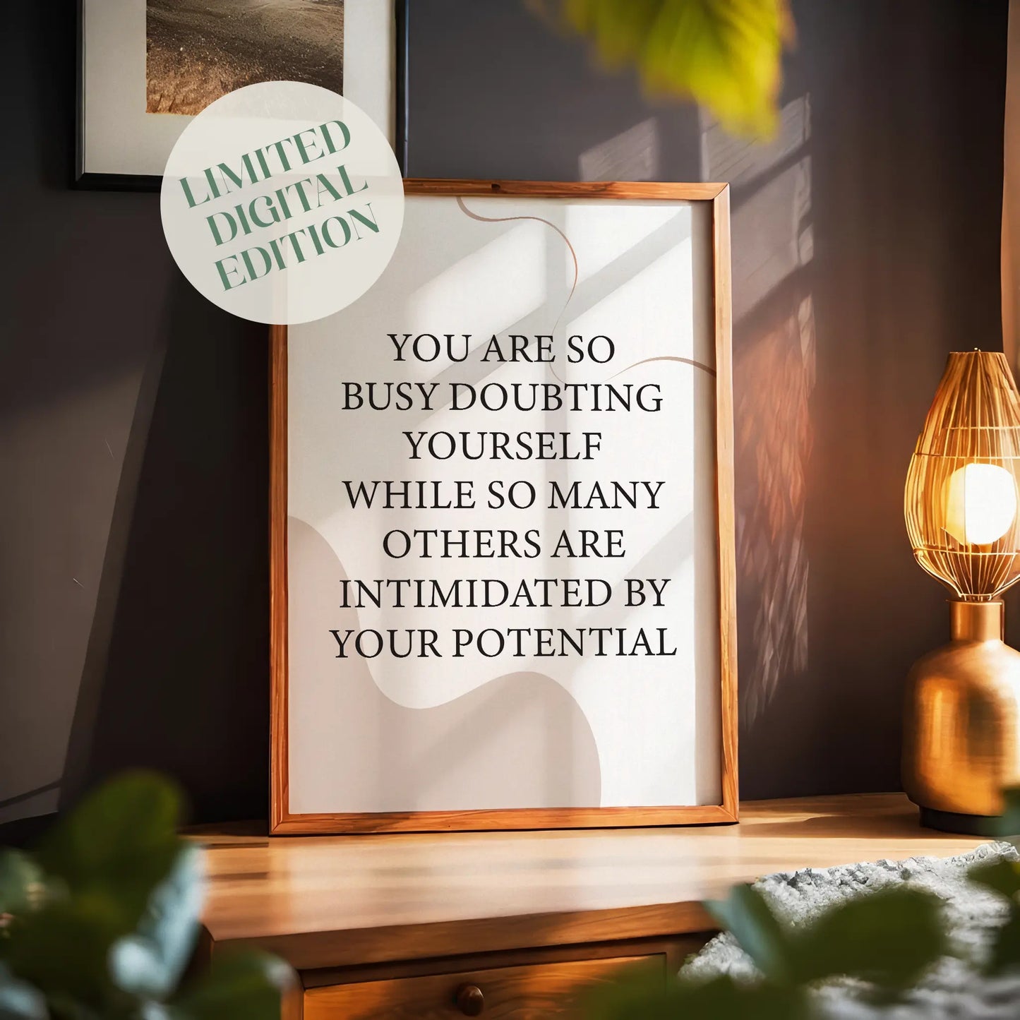 Empowering printable wall art featuring the quote 'You are so busy doubting yourself while so many others are intimidated by your potential' in classic black serif font on a soft beige background with abstract curved shapes, perfect for confidence-boosting home, office, or studio decor