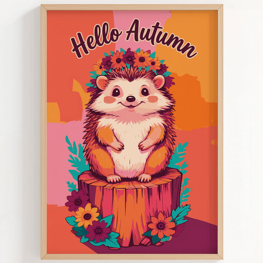 Bold illustrated "Hello Autumn" wall art featuring an adorable smiling hedgehog wearing a floral crown, seated on a tree stump with teal foliage and sunflowers on a warm orange and pink colour-blocked background