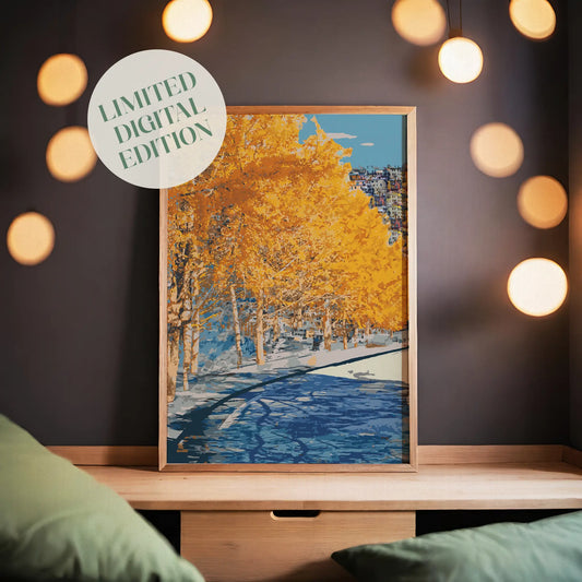 Autumn city park wall art featuring a row of golden-yellow trees along a riverbank, with reflections in the water and a hillside town in the distance under a clear blue sky