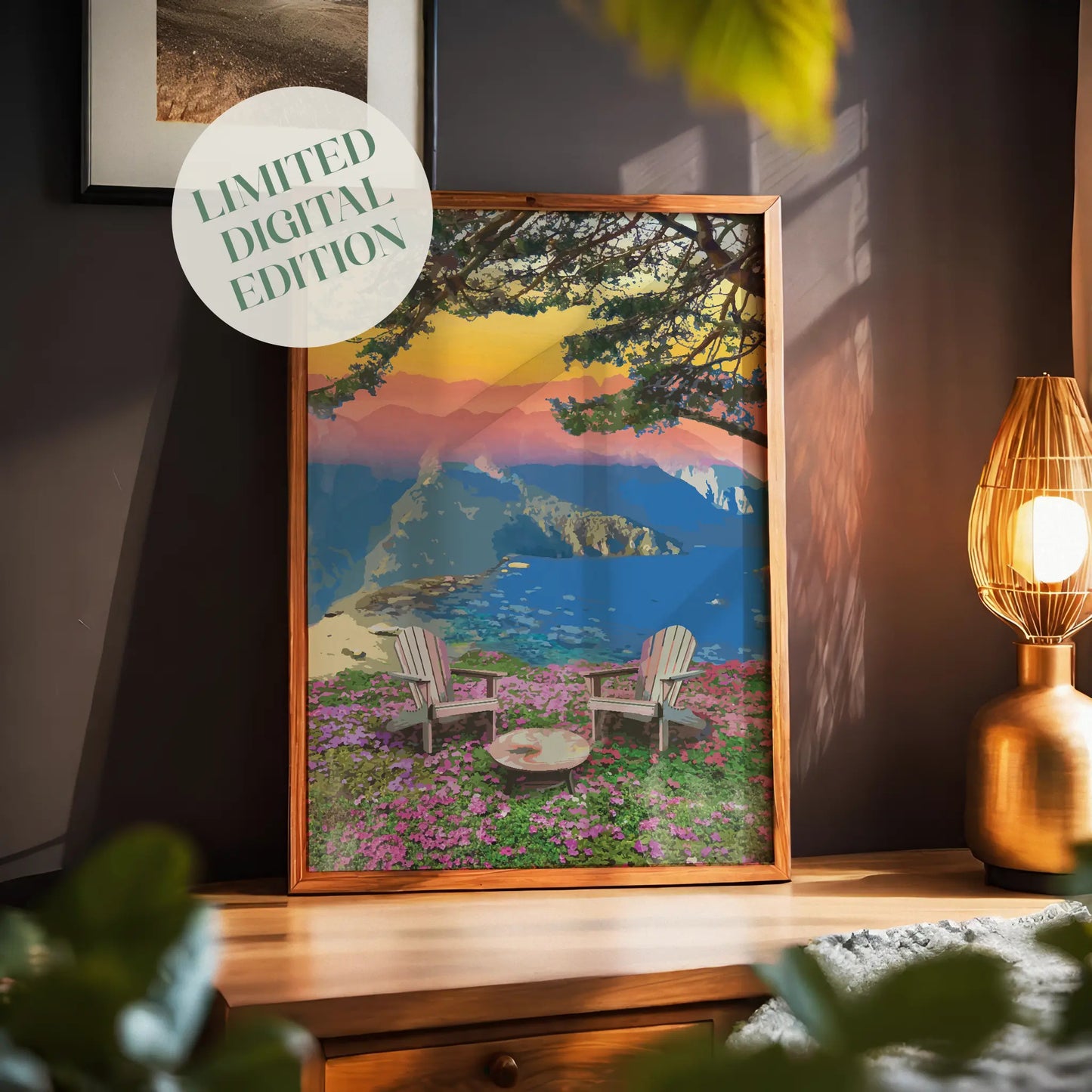 Scenic mountain view wall art featuring two Adirondack chairs and a fire pit on a field of pink wildflowers, overlooking a coastal cliff and tranquil ocean under a vibrant sunset sky with layered mountains
