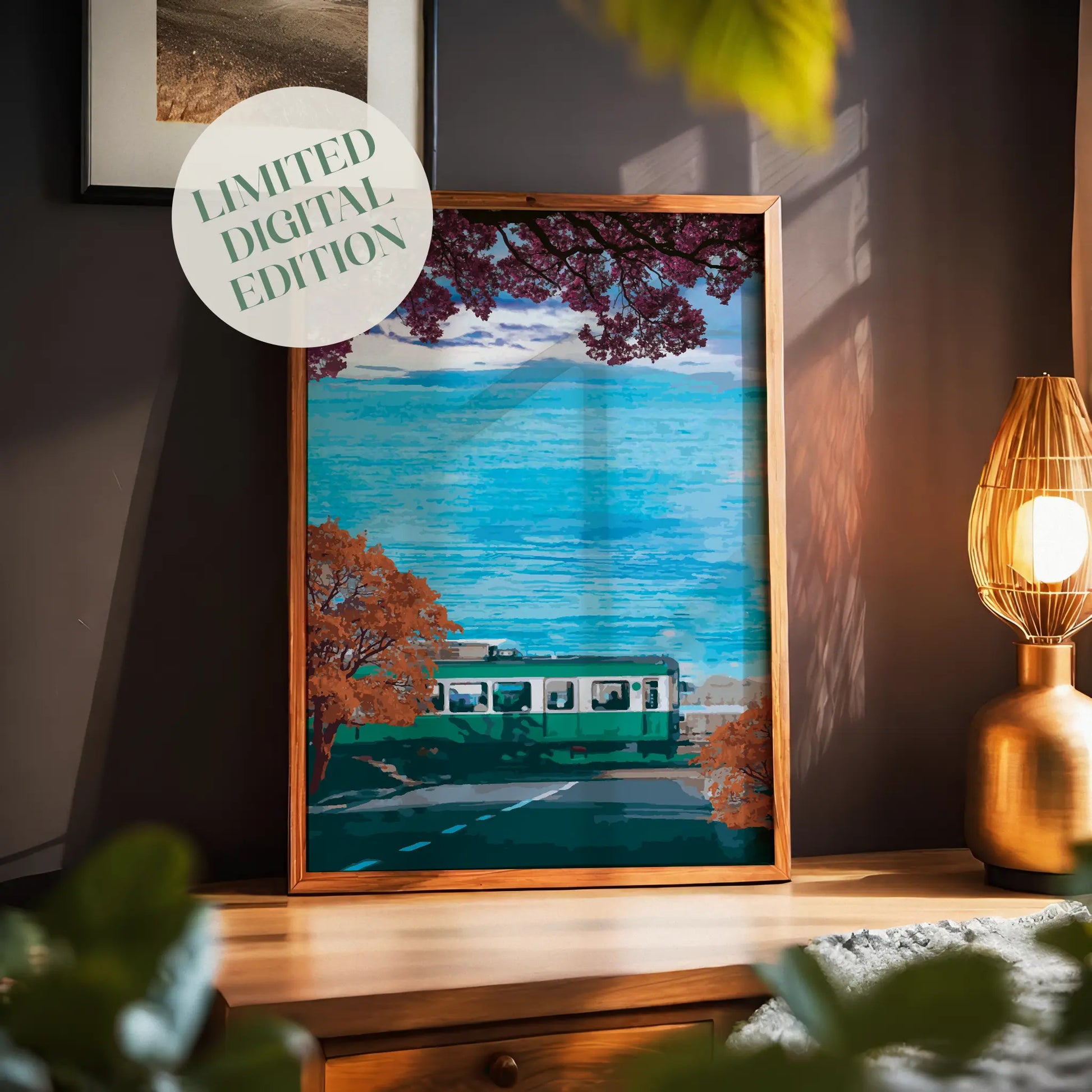 Scenic travel wall art featuring a green train passing along a coastal road lined with autumn trees, with vibrant blue ocean waves and a distant Mount Fuji under a partly cloudy sky.