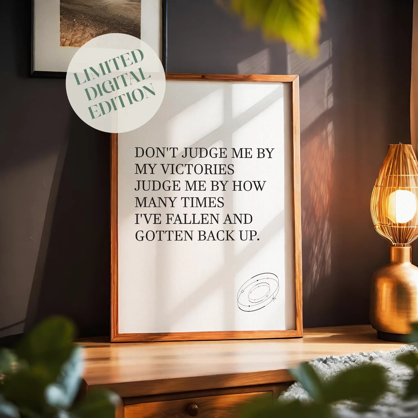 Inspirational printable wall art featuring the empowering quote 'Don't judge me by my victories, judge me by how many times I've fallen and gotten back up' in classic serif font, with a small sketched ring accent, perfect for resilience-themed or motivational spaces.